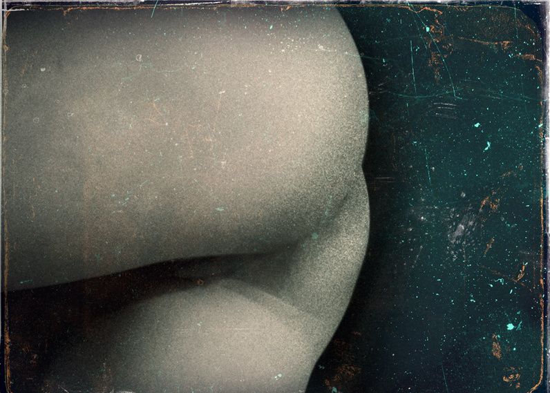 Close-up of a pale curved hip and thigh against a dark green ground, with scratches like an old plate.
