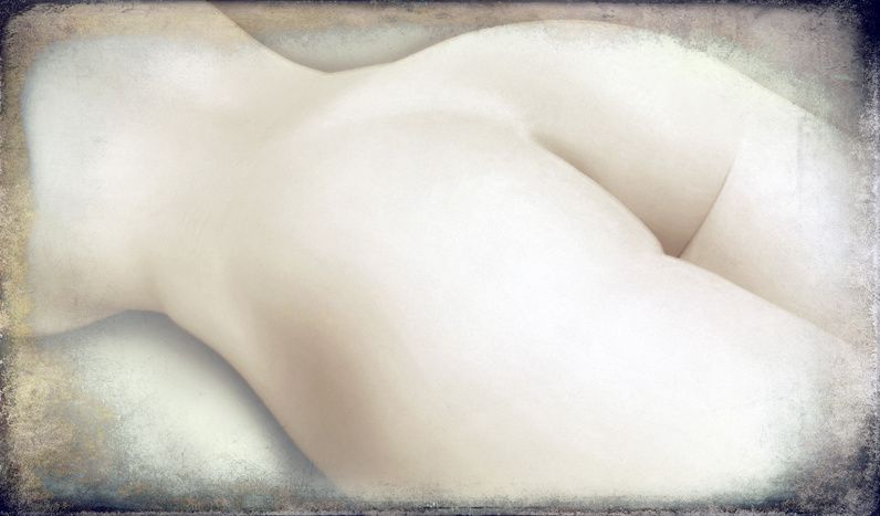 The soft curve of a pale body lying down, almost white, in a narrow horizontal frame.