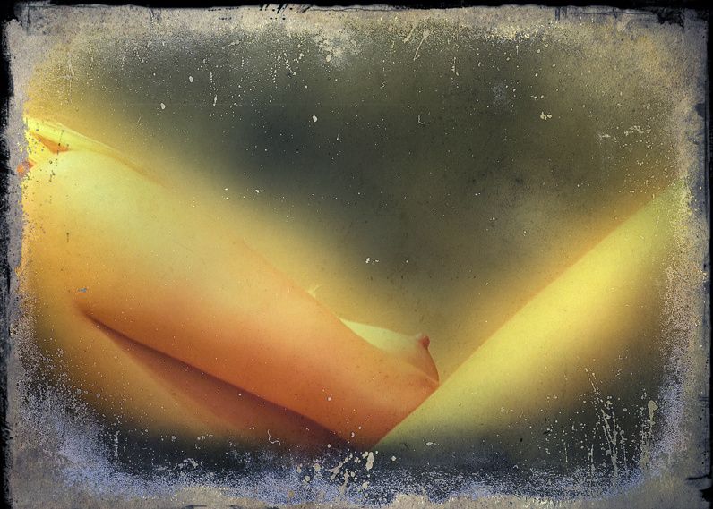 Crossed legs glowing orange inside a dark, burnt-edged frame.