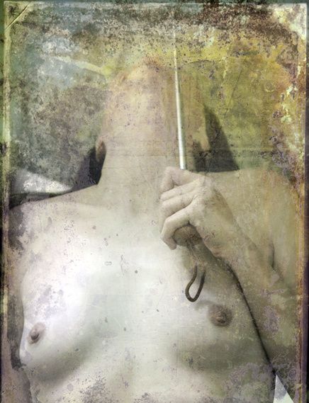 A nude torso holding a thin cord, on a pale, stained ground.
