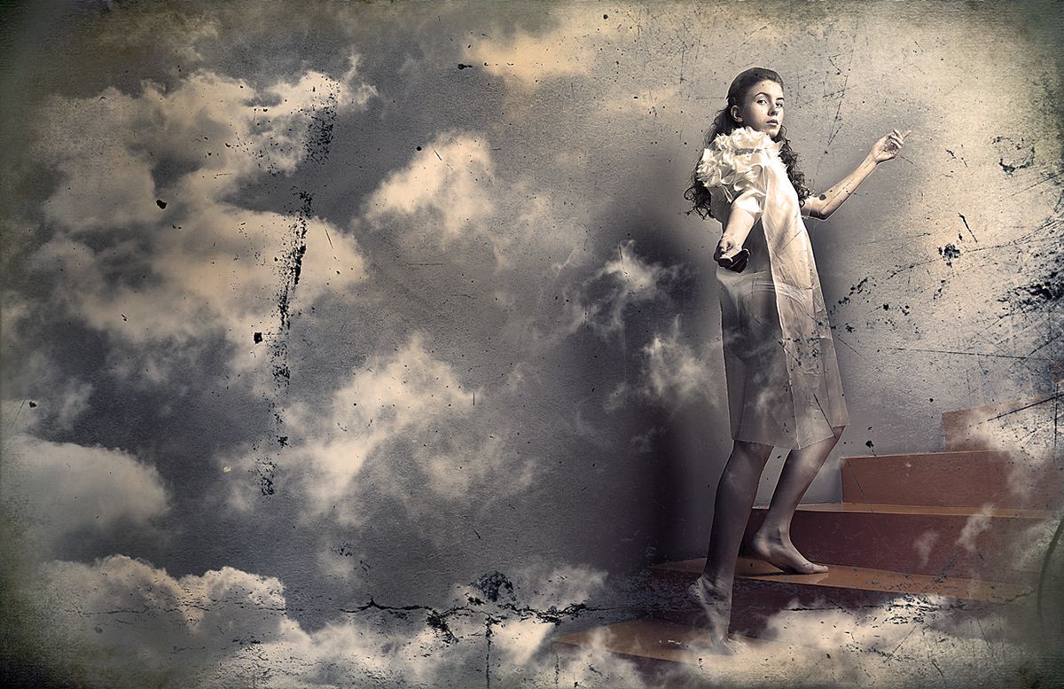 A barefoot woman in a pale dress climbing stairs into the clouds.