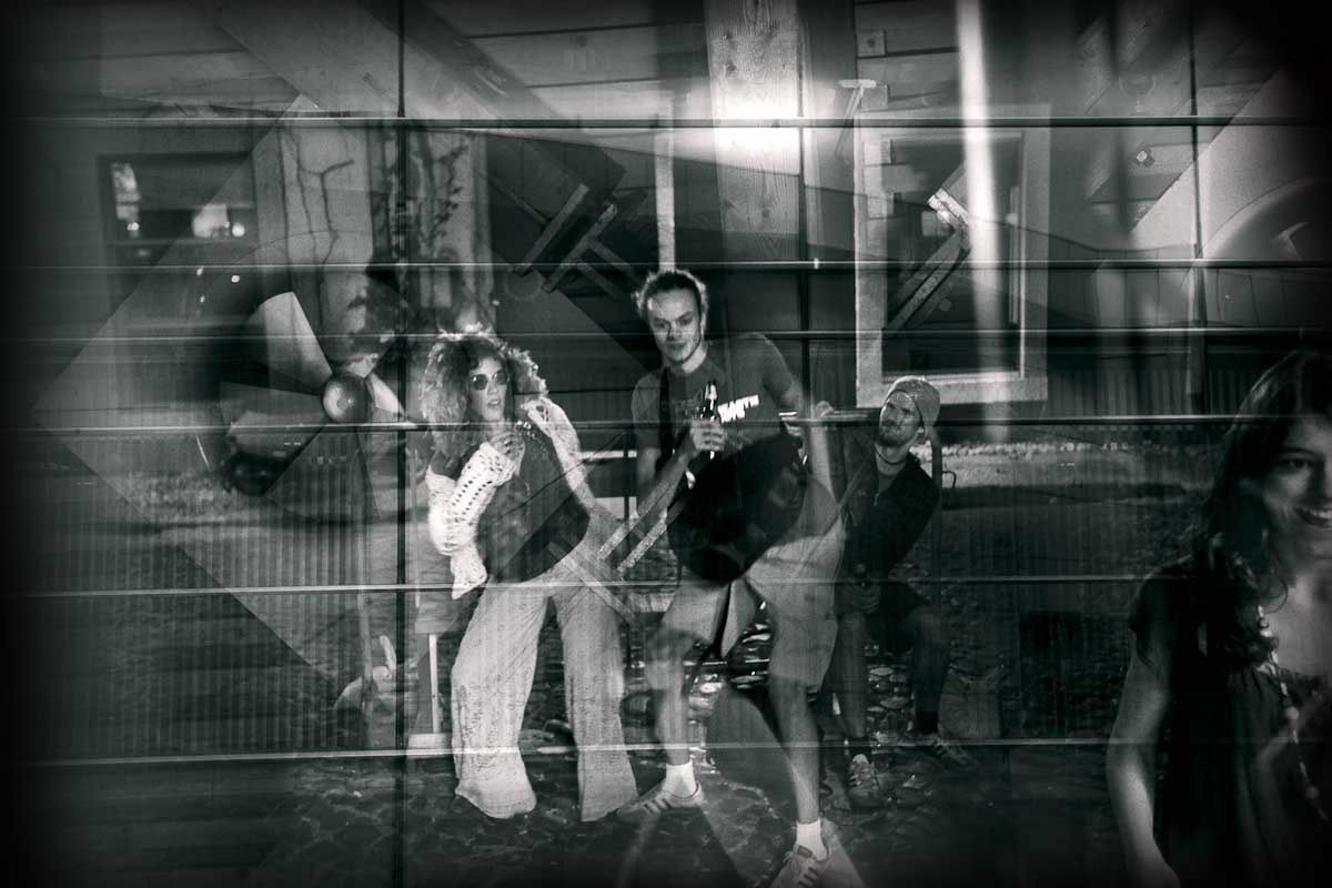 A group of young people posing among overlapping frames and shadows.