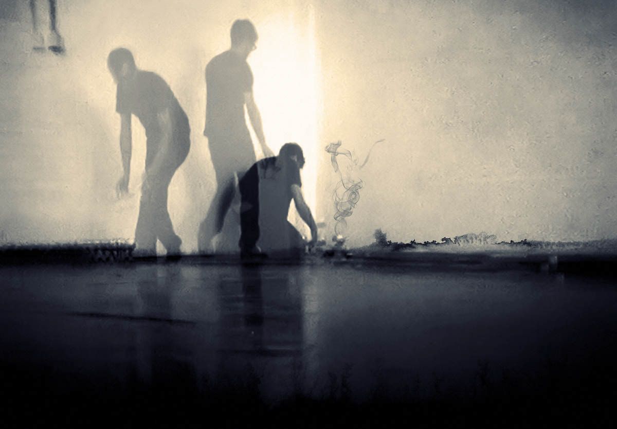 Shadowy figures bending in a bright, empty room with a reflective floor.